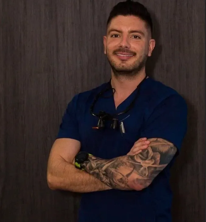 Portrait of Dr. Alejandro U. Barquero in blue scrubs
